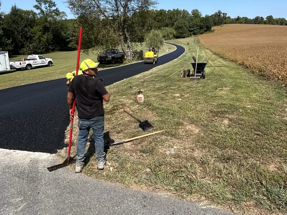 King James Asphalt crew applying professional sealcoating to a residential driveway in York County, PA